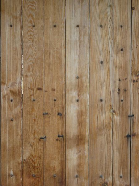 New wooden planks set vertically with bent nails.